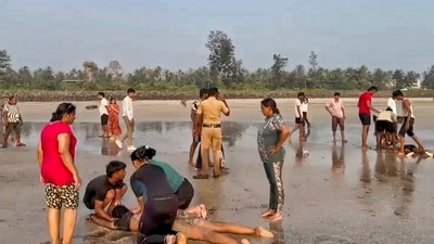 A police official at the site after eight male students of a private coaching institute, 'Winners Academy', drowned in the Arabian Sea while on a picnic at Diveagar beach. (PTI) A police official at the site after eight male students of a private coaching institute, 'Winners Academy', drowned in the Arabian Sea while on a picnic at Diveagar beach. (PTI)