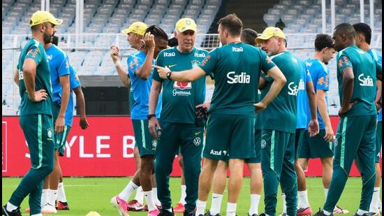 Brazil's head coach Carlos Ancelotti (C) talks with support staff as players prepare for a training in Kolkata on Friday. (AP Photo/Bikas Das)