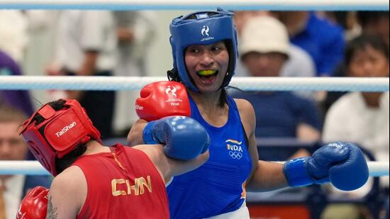 India's Lovlina Borgohain, in blue, and China's Bao Ziyi, in red, fight in their women's 75kg boxing final match at the Asian Games in Nishio, Aichi prefecture, Japan, Friday, Oct. 2, 2026. (AP Photo/Lee Jin-man) (AP Photo/Lee Jin-man)
