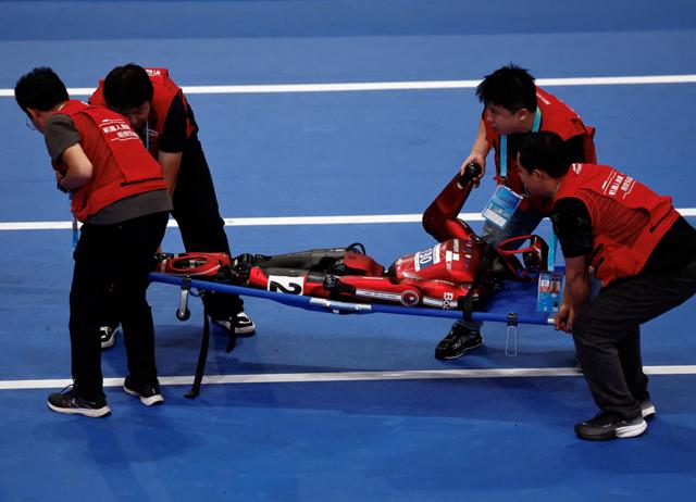 At the World Humanoid Robot Games 2026, malfunctioning robots were carried out on stretchers. (REUTERS) At the World Humanoid Robot Games 2026, malfunctioning robots were carried out on stretchers. (REUTERS)