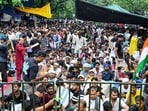 People sit at the protest site at Jantar Mantar supporting the Cockroach Janata Party's (CJP) protest, over alleged examination irregularities and NEET paper leak.