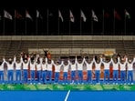 Gold medallists India celebrate on the podium during the victory ceremony.