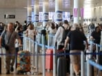 People line up at Ben Gurion International Airport after a FlyDubai aircraft bound for Israel from the United Arab Emirates was diverted to Saudi Arabia.