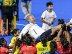 India’s players celebrate as they lift coach Sjoerd Marijne after winning the women’s gold medal. (PTI)