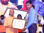 Uttar Pradesh CM Yogi Adityanath giving a certificate to a student at an event in Lucknow on October 3. (HT photo)