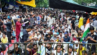 People sit at the protest site at Jantar Mantar supporting the Cockroach Janata Party's (CJP) protest, over alleged examination irregularities and NEET paper leak. (Sathiya) People sit at the protest site at Jantar Mantar supporting the Cockroach Janata Party's (CJP) protest, over alleged examination irregularities and NEET paper leak. (Sathiya)