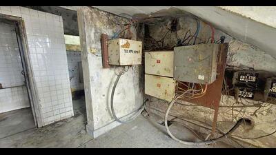 Across other sections of the building, dangling wires, deteriorating ceilings, and poorly kept rooms compound the hazardous environment. (HT) Across other sections of the building, dangling wires, deteriorating ceilings, and poorly kept rooms compound the hazardous environment. (HT)