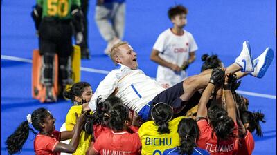 India’s players celebrate as they lift coach Sjoerd Marijne after winning the women’s gold medal. (PTI) India’s players celebrate as they lift coach Sjoerd Marijne after winning the women’s gold medal. (PTI)