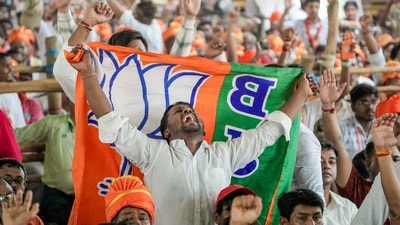 North 24 Parganas: A supporter holds a BJP flag during an election campaign rally addressed by Prime Minister Narendra Modi in support of party candidate Ratna Debnath and others at Panihati, in North 24 Parganas district of West Bengal, Friday, April 24, 2026. (PTI Photo/Swapan Mahapatra)(PTI04_24_2026_000110A) North 24 Parganas: A supporter holds a BJP flag during an election campaign rally addressed by Prime Minister Narendra Modi in support of party candidate Ratna Debnath and others at Panihati, in North 24 Parganas district of West Bengal, Friday, April 24, 2026. (PTI Photo/Swapan Mahapatra)(PTI04_24_2026_000110A)