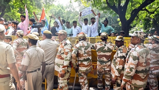 Security personnel stop protesters with barricades on a road near Jantar Mantar during a protest seeking Chief Election Commissioner Gyanesh Kumar's resignation over voter roll deletions, in New Delhi on Friday.