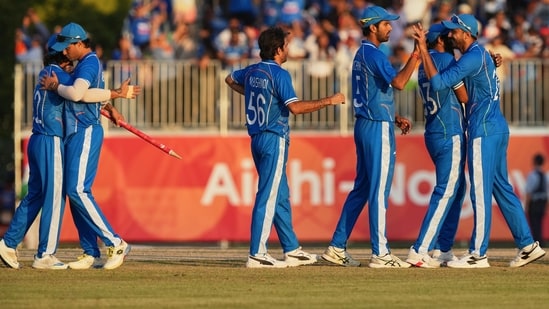 Indian team members celebrate after winning gold medal cricket match between India and Pakistan at the Asian Games in Nagoya, Japan