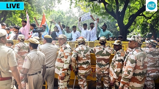 Security personnel stop protesters with barricades on a road near Jantar Mantar during a protest seeking Chief Election Commissioner Gyanesh Kumar's resignation over voter roll deletions, in New Delhi on Friday.