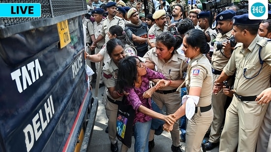 Police detain a woman protester near Jantar Mantar during a protest seeking Chief Election Commissioner Gyanesh Kumar's resignation over voter roll deletions, in New Delhi on Friday.