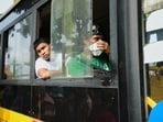 Myanmar nationals who were sent back from Malaysia look from a bus as they leave a Myanmar Navy base on Sunday. 