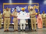 Punjab chief minister felicitating police personnel during an “SHO Milni” at Maharaja Ranjit Singh Academy in Phillaur on Saturday. (HT)
