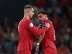 Portugal's Cristiano Ronaldo hands the captain's armband to Bruno Fernandes as he is substituted off 