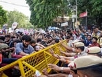 Protesters try to breach security barricades during a protest near Jantar Mantar, in New Delhi on Saturday.(ANI)