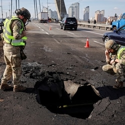 Police officers work at a site of the North Bridge hit by a Russian drone strike, amid Russia's attack on Ukraine, in Kyiv, Ukraine October 4, 2026.