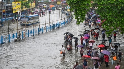 Commuters wade throught waterlogged roads in Kolkata under their umbrellas as rains continue to lash the city of joy since last night ahead of the state's biggest festival Durga Puja. Commuters wade throught waterlogged roads in Kolkata under their umbrellas as rains continue to lash the city of joy since last night ahead of the state's biggest festival Durga Puja.