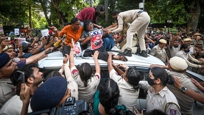 Several supporters climb atop a police vehicle carrying AISA leader Neha Bora after she was detained during a protest march by members of AISA and other student organisations demanding the resignation of CEC Gyanesh Kumar. (Sanchit Khanna/HT Photos) Several supporters climb atop a police vehicle carrying AISA leader Neha Bora after she was detained during a protest march by members of AISA and other student organisations demanding the resignation of CEC Gyanesh Kumar. (Sanchit Khanna/HT Photos)