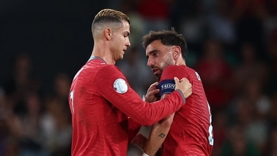 Portugal's Cristiano Ronaldo hands the captain's armband to Bruno Fernandes as he is substituted off (REUTERS)
