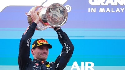 Red Bull driver Max Verstappen of the Netherlands celebrates with his trophy on the podium after winning the Bahrain Grand Prix. Red Bull driver Max Verstappen of the Netherlands celebrates with his trophy on the podium after winning the Bahrain Grand Prix.