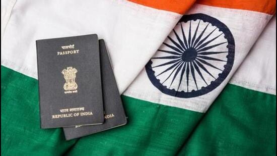 Indian passport and authentic indian tricolour flag made up of khadi or pure cotton material - Stock image (Getty Images/iStockphoto)