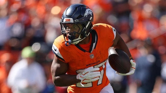 J.K. Dobbins #27 of the Denver Broncos runs with the ball.