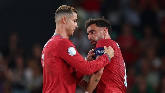 Portugal's Cristiano Ronaldo hands the captain's armband to Bruno Fernandes as he is substituted off 