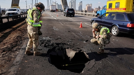 Police officers work at a site of the North Bridge hit by a Russian drone strike, amid Russia's attack on Ukraine, in Kyiv, Ukraine October 4, 2026.