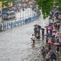 Commuters wade throught waterlogged roads in Kolkata under their umbrellas as rains continue to lash the city of joy since last night ahead of the state's biggest festival Durga Puja.