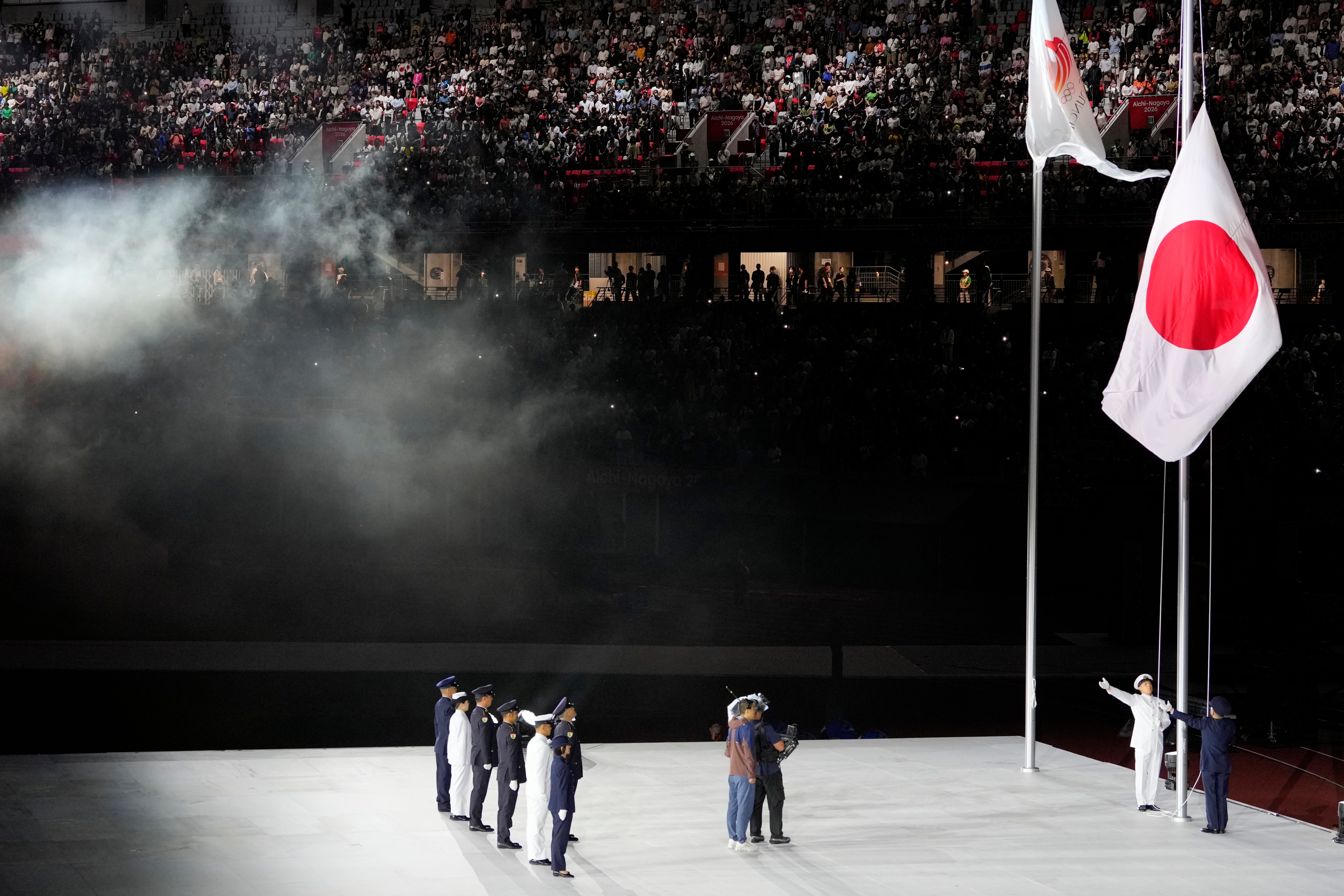 The Japanese flag is raised during the closing ceremony (AP Photo/Eugene Hoshiko)