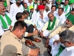 A Haryana government official listens to the grievances raised by farmer leader Rakesh Tikait and others during the blockade in Yamunanagar on Sunday. (HT Photo)