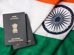 Indian passport and authentic indian tricolour flag made up of khadi or pure cotton material - Stock image (Getty Images/iStockphoto)