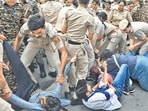 Police personnel detain members of the AISA, SFI, and other student organisations during a protest on October 4 (Arvind Yadav/HT) Police personnel detain members of the AISA, SFI, and other student organisations during a protest on October 4 (Arvind Yadav/HT)