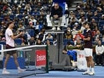 Serbia's Novak Djokovic (R) and Germany's Alexander Zverev argue with the referee during their men's singles quarter-final at the China Open