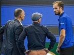 Russia's Daniil Medvedev (R) speaks with the match umpire (L) and an ATP official after he was disqualified for hitting a ball into the stands, injuring a spectator,