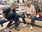 Art teacher Juliette Zielke shops at Alamo Shoes in Chicago for footwear for weddings and work. Helping her is owner Richard Price, who has to pay for two weddings for his children, joking, ‘I’m stimulating the economy.’&nbsp;