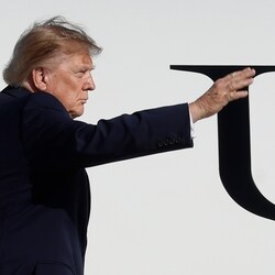 President Donald Trump waves from the stairs of Air Force One upon his departure at Joint Base Andrews, Md., Monday, Oct. 5.