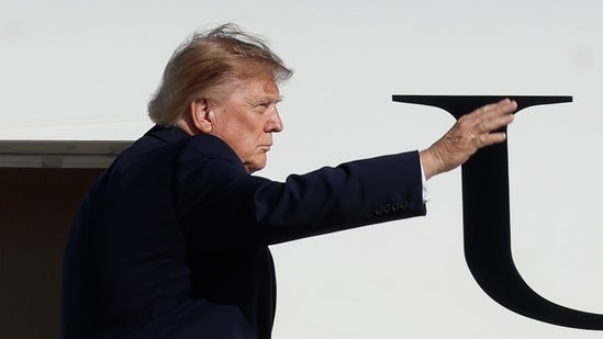 President Donald Trump waves from the stairs of Air Force One upon his departure at Joint Base Andrews, Md., Monday, Oct. 5.