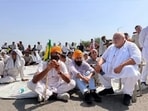 A group of farmers blocking a national highway outside Assandh grain market in Karnal on Monday. (HT Photo)