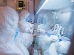 This undated photo released in 2019 by the Irkutsk Anti-Plague Research Institute of Siberia and Far East, shows the institute workers in a lab.(The Irkutsk Anti-Plague Research)
