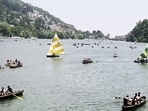 Tourists and devotees take a boat ride at Shree Kainchi Dham - Param Pujya Baba Shri Neeb Karori Maharaj near Bhowali Range, in Nainital on Saturday.