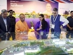 Chief minister Yogi Adityanath looks at a model layout of the campus during the 10th-anniversary celebrations of HCLTech Lucknow, in Lucknow on Tuesday. (ANI)