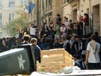 French high school students gather outside the Lycée Sophie Germain high school as part of nationwide protests. 