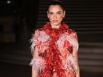 Several stars were present at the showcase, including singer-songwriter Dua Lipa. She was clicked posing upon arrival, dressed in a red dress adorned with feathered elements. She styled it with a bejewelled Chanel bag.&nbsp;