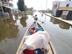 Residents travel along a flooded road in the Daudnagar area of Faizullaganj in Lucknow, on Monday. (Deepak Gupta/HT)