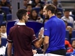 Russia's Daniil Medvedev with Serbia's Novak Djokovic after being disqualified from his semi-final match for hitting a ball into the crowd, injuring a spectator