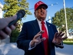 US President Donald Trump speaks to members of the media on the South Lawn of the White House after arriving on Marine One in Washington, DC, US.