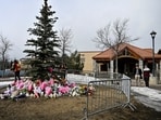 Workers install a fence around a makeshift memorial for the victims two days after a deadly mass shooting took place at a school in the town of Tumbler Ridge, British Columbia, Canada. REUTERS/Jennifer Gauthier/File Photo(REUTERS)